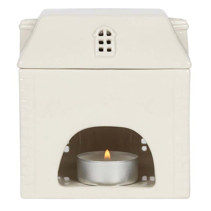 
                  
                    White Ceramic House Oil Burner with tealight burning inside
                  
                